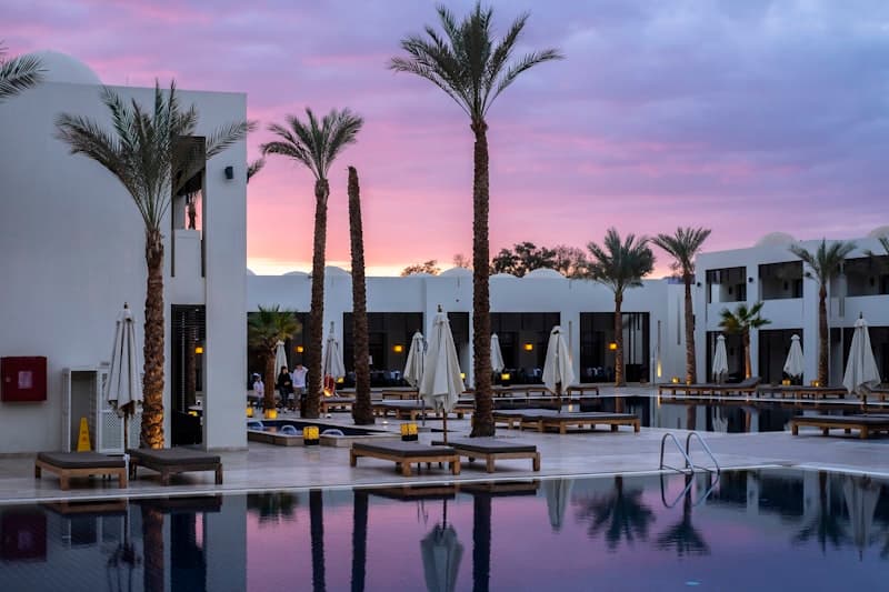 Luxury hotel with pool at sunset